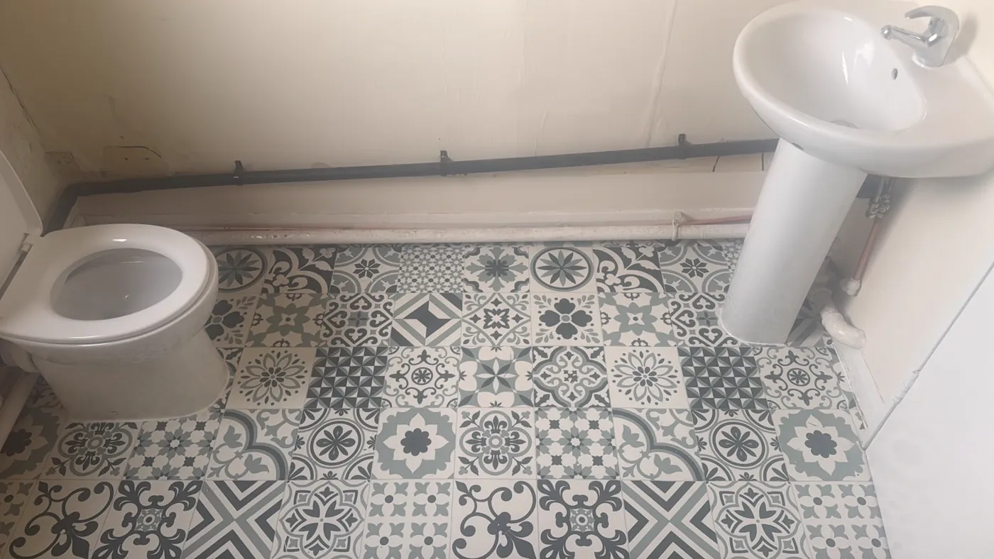 Bathroom with a patterned tile floor