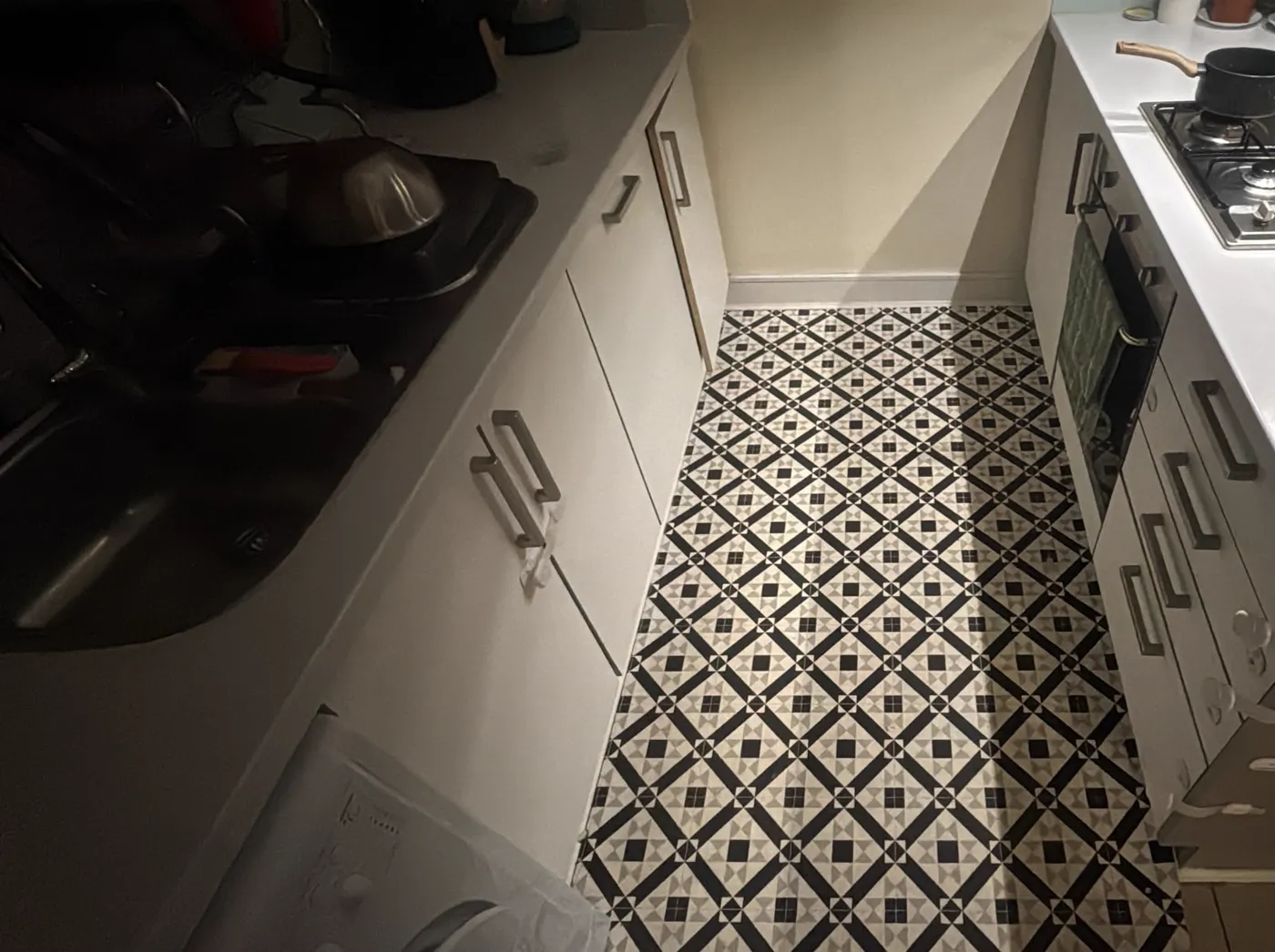 Kitchen floor with a black and white tile pattern