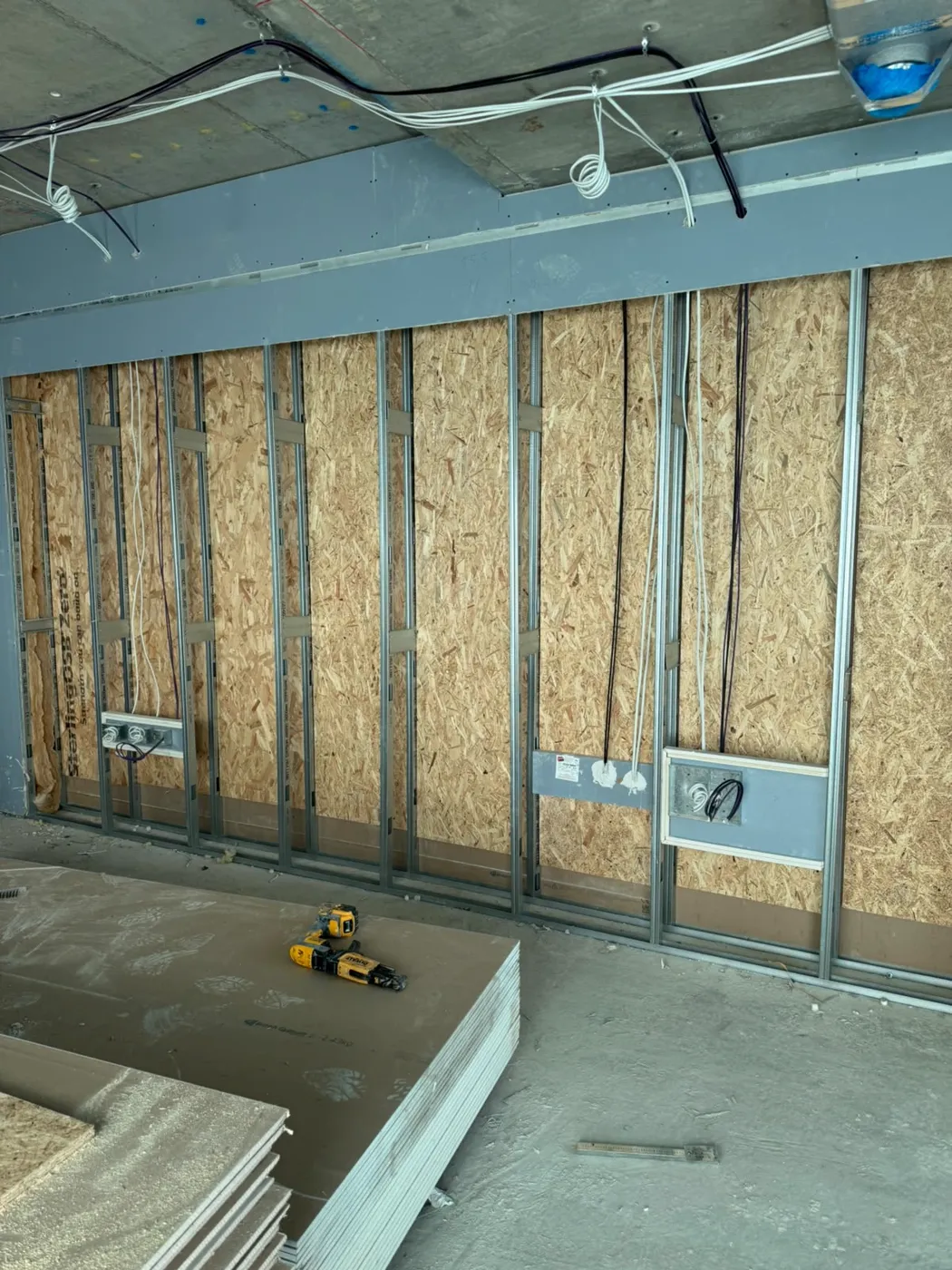 Metal stud partition with boards and sockets