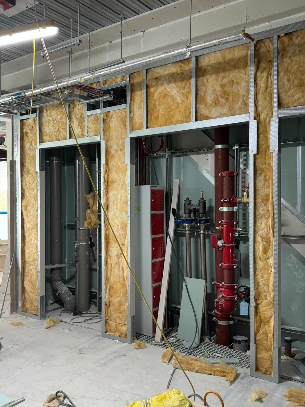 Plasterboard and metal stud walls around services