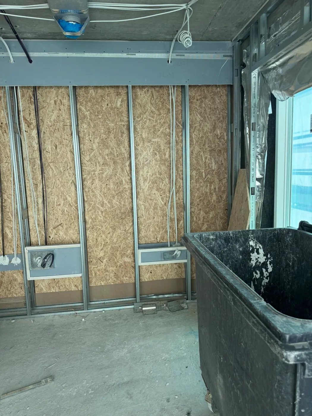 Metal stud wall with insulation and boards